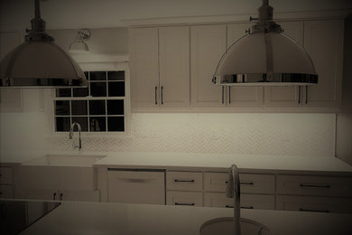 Trendy l-shaped eat-in kitchen photo in Seattle with a farmhouse sink, shaker cabinets, white cabinets, white backsplash, ceramic backsplash, white appliances, an island and white countertops