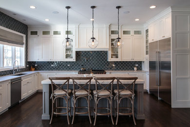 Large transitional u-shaped dark wood floor eat-in kitchen photo in Chicago with shaker cabinets, white cabinets, an island, an undermount sink, marble countertops, glass tile backsplash, stainless steel appliances and gray backsplash