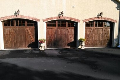 This is an example of a large traditional attached three-car garage in Philadelphia.