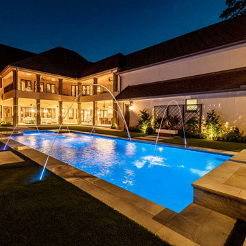 Rectangular pool, covered patio and kitchen, outdoor shower, landscaping