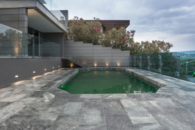 Small modern backyard rectangular lap pool in Sydney with tile.