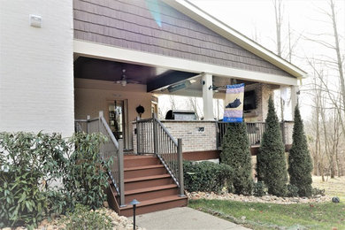 Inspiration for a large timeless backyard outdoor kitchen deck remodel in Louisville with a roof extension