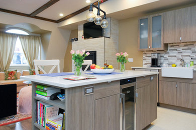 Mid-sized trendy l-shaped porcelain tile open concept kitchen photo in Boston with a farmhouse sink, flat-panel cabinets, gray cabinets, quartz countertops, gray backsplash, ceramic backsplash, colored appliances and an island