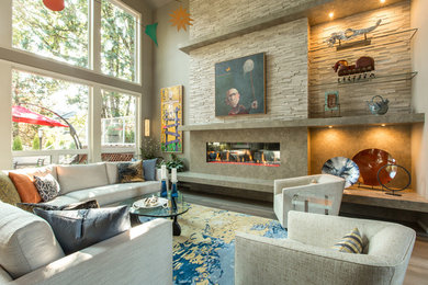 Example of a trendy formal and enclosed medium tone wood floor living room design in Portland with beige walls, a ribbon fireplace, a stone fireplace and no tv