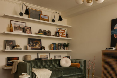 Inspiration for a transitional dark wood floor and brown floor living room remodel in New York with beige walls
