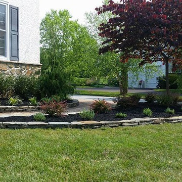 Flagstone wall around planting beds and installation of new plant material