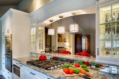 Mid-sized elegant galley dark wood floor and brown floor enclosed kitchen photo in Charlotte with a farmhouse sink, recessed-panel cabinets, white cabinets, granite countertops, stainless steel appliances and no island
