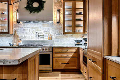 Inspiration for a transitional light wood floor and vaulted ceiling kitchen remodel with medium tone wood cabinets, quartzite countertops and an island