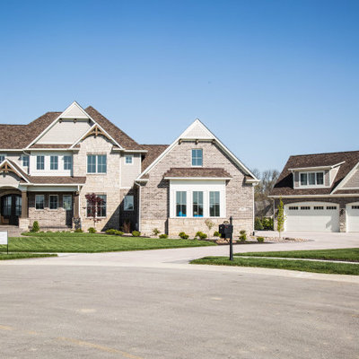 Inspiration for a huge timeless brown two-story brick and clapboard exterior home remodel in Indianapolis with a shingle roof and a brown roof