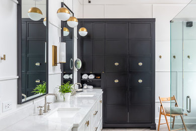 Example of a mid-sized farmhouse master white tile and ceramic tile porcelain tile and brown floor bathroom design in Raleigh with recessed-panel cabinets, white cabinets, a two-piece toilet, white walls, an undermount sink, marble countertops, a hinged shower door and white countertops