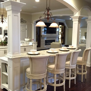 This is an example of an expansive victorian u-shaped kitchen pantry in Other with an undermount sink, raised-panel cabinets, white cabinets, granite benchtops, white splashback, stainless steel appliances and multiple islands.