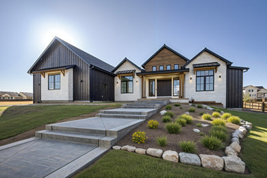 Large transitional black one-story wood and board and batten exterior home photo in Denver with a shingle roof and a black roof