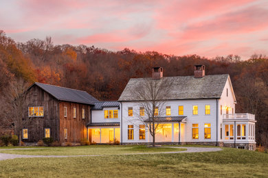 Traditional white two-story clapboard exterior home idea in New York with a shingle roof and a gray roof