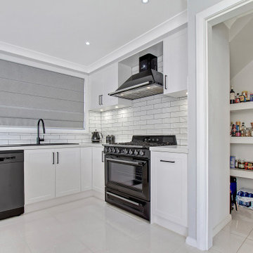 Clean White U Shaped Kitchen with Walk In Pantry