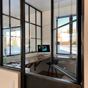 Custom glass wall with a dutch door French artist studio inspired office space