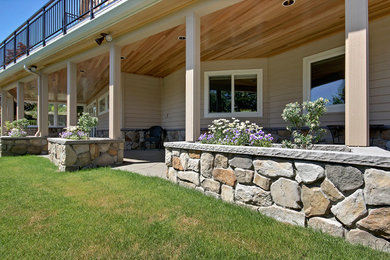 Inspiration for a large craftsman backyard concrete patio container garden remodel in Seattle with a roof extension