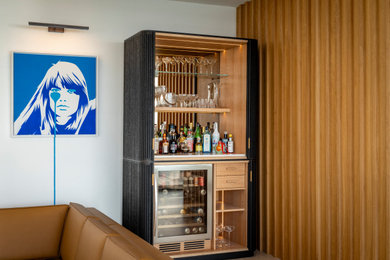 Photo of a medium sized contemporary home bar in Sussex with white worktops and a feature wall.