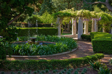 Photo of an expansive traditional garden in Santa Barbara with brick pavers.