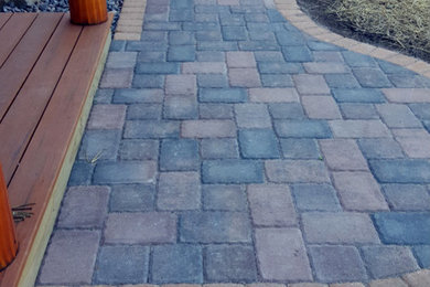 Inspiration for a rustic partial sun front yard concrete paver landscaping in Other for summer.