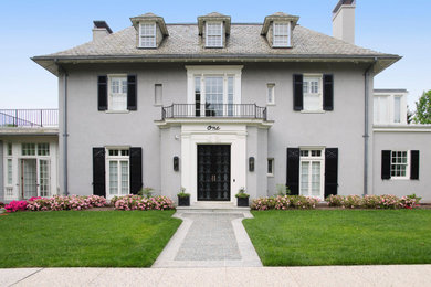 Example of a classic gray two-story house exterior design in Baltimore with a hip roof, a shingle roof and a brown roof