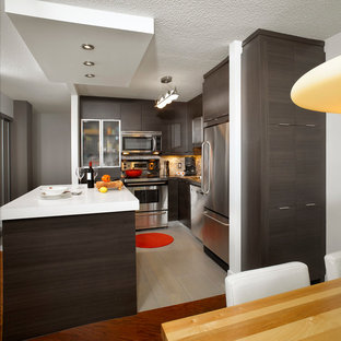 Mid-sized modern kitchen pantry appliance - Mid-sized minimalist l-shaped ceramic floor kitchen pantry photo in Montreal with a drop-in sink, flat-panel cabinets, dark wood cabinets, quartzite countertops, multicolored backsplash, cement tile backsplash, stainless steel appliances and an island