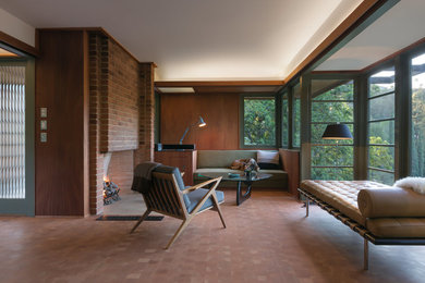 Inspiration for a large midcentury living room in Los Angeles with medium hardwood floors, a standard fireplace and a brick fireplace surround.