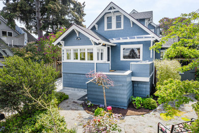 Inspiration for a craftsman blue two-story wood and shingle house exterior remodel in Seattle with a shingle roof and a gray roof