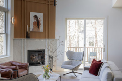 Large minimalist formal and open concept medium tone wood floor, vaulted ceiling and wood wall living room photo in Boston with white walls, a corner fireplace and a stone fireplace