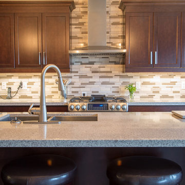 Falsetta - Brown Cabinets with Mosaic Tile Backsplash
