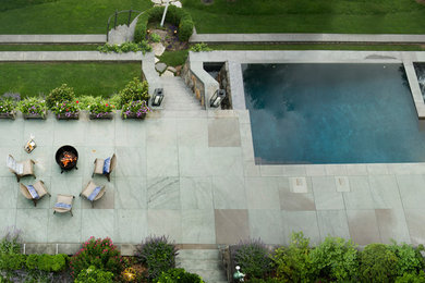 Example of a mid-sized trendy backyard stone and rectangular lap hot tub design in New York