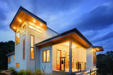 Large contemporary gray two-story clapboard house exterior idea in Other