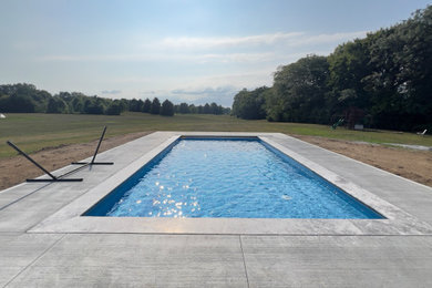 Mid-sized minimalist backyard stone and rectangular pool photo in Columbus