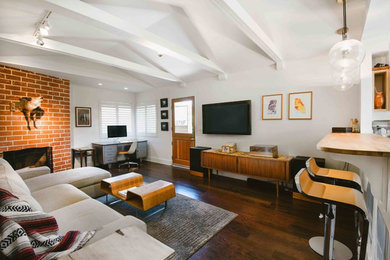 Inspiration for a small 1950s open concept and formal dark wood floor living room remodel in Orange County with white walls, a standard fireplace, a brick fireplace and a wall-mounted tv