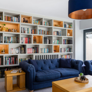 LUXURY FULLY FITTED LIVING ROOM WITH BESPOKE BOOKCASES AND MEDIA WALL
