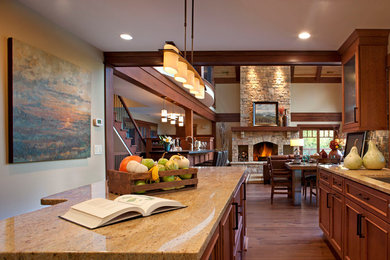Mid-sized transitional l-shaped medium tone wood floor kitchen photo in Other with an undermount sink, beaded inset cabinets, light wood cabinets, granite countertops, multicolored backsplash and stone tile backsplash