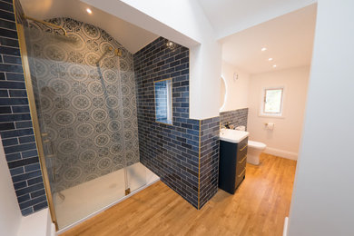 Photo of a medium sized contemporary shower room bathroom in Other with freestanding cabinets, blue cabinets, a walk-in shower, blue tiles, ceramic tiles, a single sink and a freestanding vanity unit.