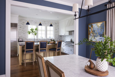 Mid-sized transitional medium tone wood floor and brown floor dining room photo in Seattle with blue walls