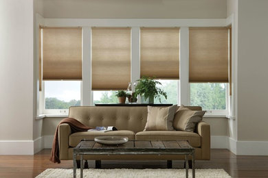 Example of a large minimalist open concept light wood floor living room design in Denver with beige walls