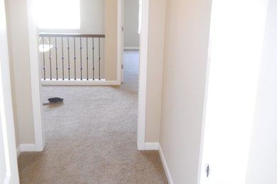Mid-sized traditional hallway in Seattle with carpet and beige walls.