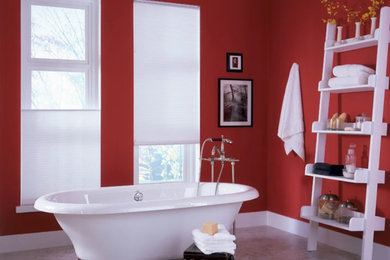 Mid-sized asian master bathroom in Dallas with a freestanding tub, red walls and grey floor.