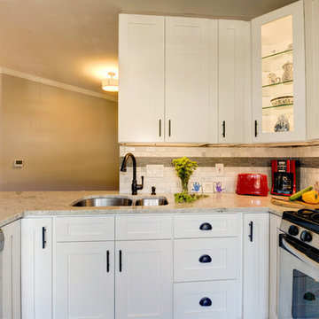White Kitchen Remodel with Colonial White Granite and Stainless Steel Appliances