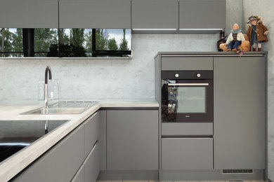 Contemporary kitchen in Berlin with flat-panel cabinets and tile benchtops.