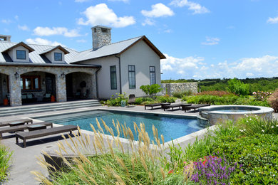 Inspiration for a mid-sized timeless beige mixed siding exterior home remodel in Houston with a metal roof