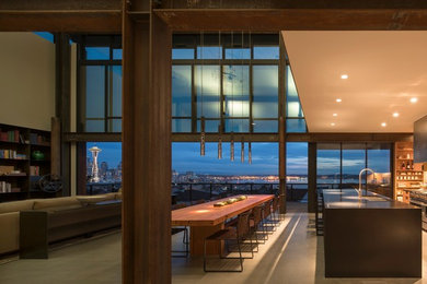 Inspiration for an industrial concrete floor and gray floor great room remodel in Seattle with beige walls