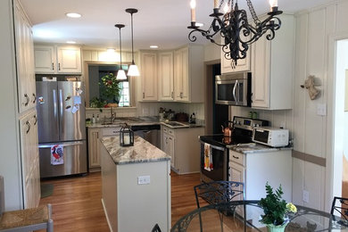 Eat-in kitchen - mid-sized traditional u-shaped medium tone wood floor eat-in kitchen idea in Richmond with an undermount sink, raised-panel cabinets, beige cabinets, granite countertops, stainless steel appliances and an island