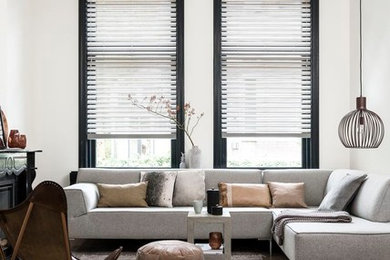 Mid-sized scandinavian open concept living room in Melbourne with white walls, light hardwood floors and beige floor.