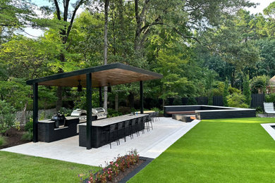 Patio kitchen - modern backyard tile patio kitchen idea in Other with a pergola