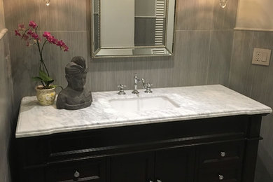 Mid-sized trendy 3/4 slate floor and gray floor bathroom photo in Miami with furniture-like cabinets, dark wood cabinets, a two-piece toilet, gray walls, an undermount sink and marble countertops