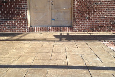 Small classic stamped concrete front porch idea in Other with a roof extension