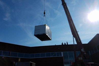 Preferred Air's early morning lift with new package units in Beverly Ma.